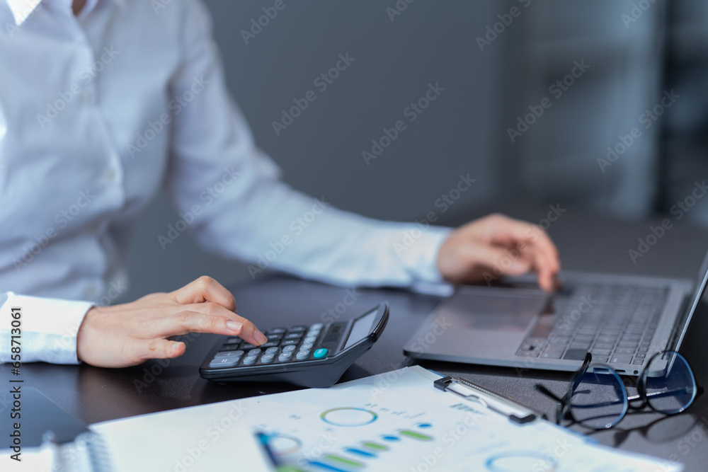 Asian businessman using laptop computer and smartphone contact business search information on desk in the office. checks mail, Asian businessman using laptop computer and smartphone contact business search information on desk in the office. checks mail,
