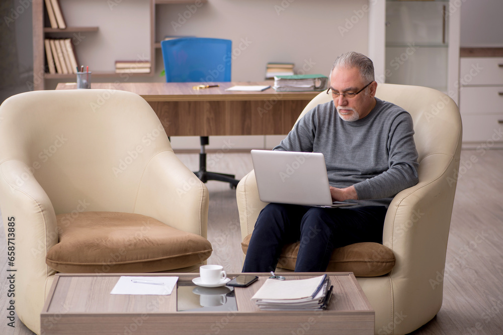 Old male employee working from home during pandemic Old male employee working from home during pandemic