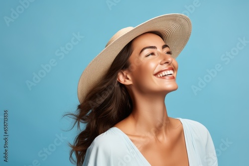 A woman wearing a hat and smiling