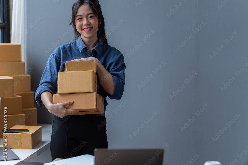 startup girl Small SME business owners work with laptop computers at work. with parcel paper boxes for delivery to customers online selling, Ecommerce, startup girl Small SME business owners work with laptop computers at work. with parcel paper boxes for delivery to customers online selling, Ecommerce,