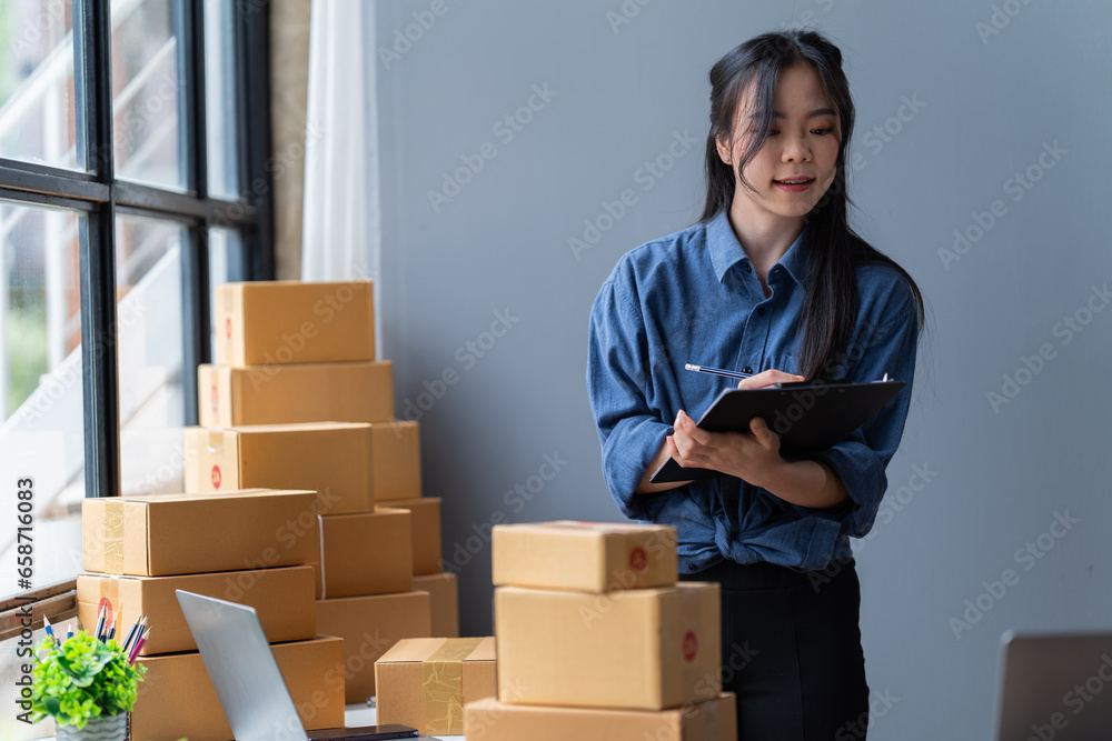 startup girl Small SME business owners work with laptop computers at work. with parcel paper boxes for delivery to customers online selling, Ecommerce, startup girl Small SME business owners work with laptop computers at work. with parcel paper boxes for delivery to customers online selling, Ecommerce,