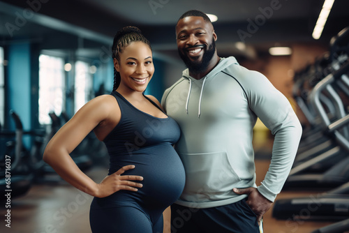 portrait pregnant african american couple in gym, family man and woman does sport together in sportswear, black sporty expecting lady , Healthy lifestyle during pregnancy.