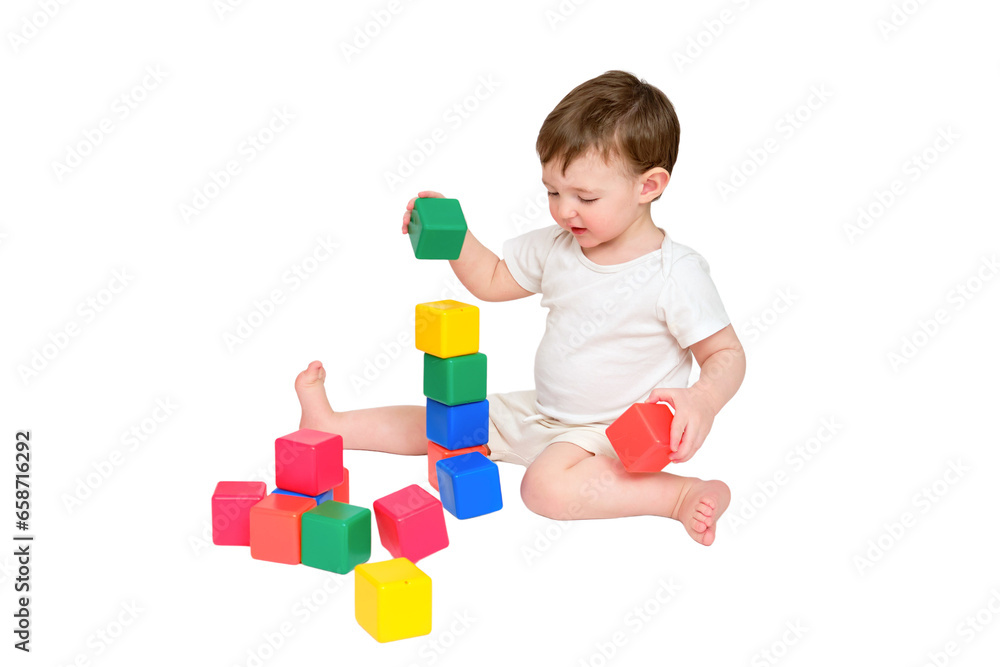 Happy baby play educational toys on studio, isolated on white background. Portrait of a smiling child playing while sitting on the floor, isolated on white background. Kid about two years old Happy baby play educational toys on studio, isolated on white background. Portrait of a smiling child playing while sitting on the floor, isolated on white background. Kid about two years old