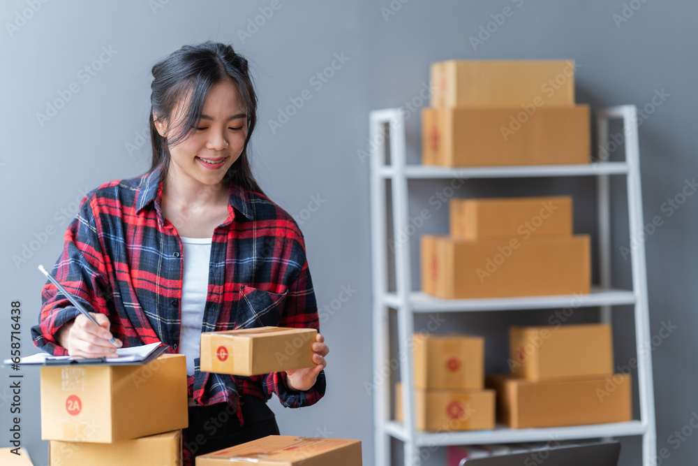 startup girl Small SME business owners work with laptop computers at work. with parcel paper boxes for delivery to customers online selling, Ecommerce, startup girl Small SME business owners work with laptop computers at work. with parcel paper boxes for delivery to customers online selling, Ecommerce,