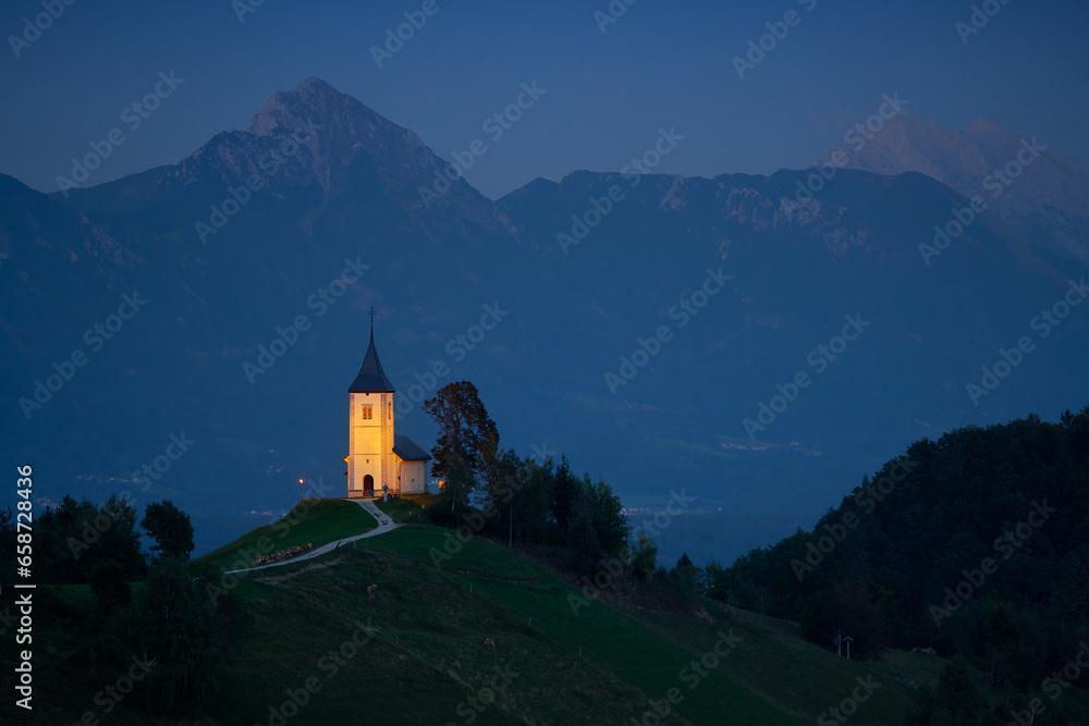 Illuminated The Church of St. Primoz and Felicijan in the village of Jamnik in the Slovenian Alps at night. Illuminated The Church of St. Primoz and Felicijan in the village of Jamnik in the Slovenian Alps at night.