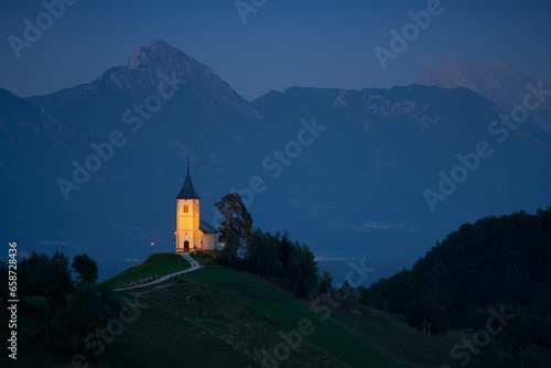 Illuminated The Church of St. Primoz and Felicijan in the village of Jamnik in the Slovenian Alps at night.