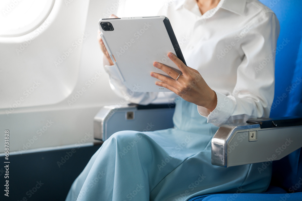 travel and technology Fly in first class Beautiful Asian businesswoman working using laptop computer while sitting on airplane travel and technology Fly in first class Beautiful Asian businesswoman working using laptop computer while sitting on airplane