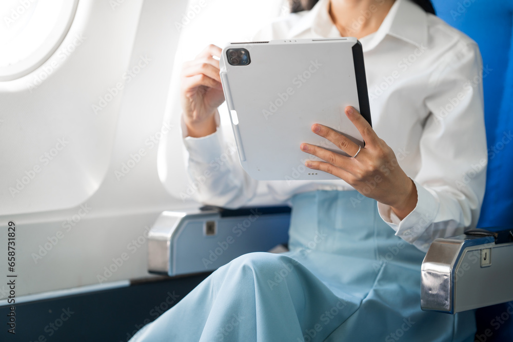 travel and technology Fly in first class Beautiful Asian businesswoman working using laptop computer while sitting on airplane travel and technology Fly in first class Beautiful Asian businesswoman working using laptop computer while sitting on airplane