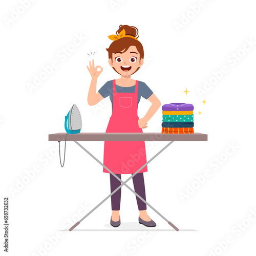 young woman ironing clean clothes and feel happy