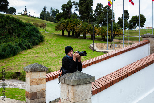 Male tourist taking photos at the famous historic Bridge of Boyaca in Colombia. The Colombian independence Battle of Boyaca took place here on August 7, 1819. photo