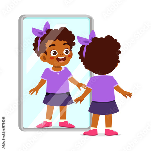 little kid standing in front of mirror