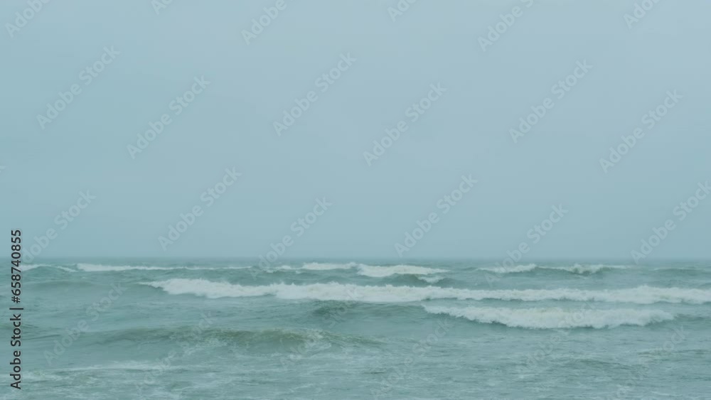 Fog over the Baltic Sea in Kaliningrad. Waves rage in gloomy cloudy weather. Fog over the Baltic Sea in Kaliningrad. Waves rage in gloomy cloudy weather.