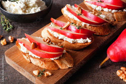 Canvas Print Crostini appetizers with red pears, whipped feta cheese and walnuts
