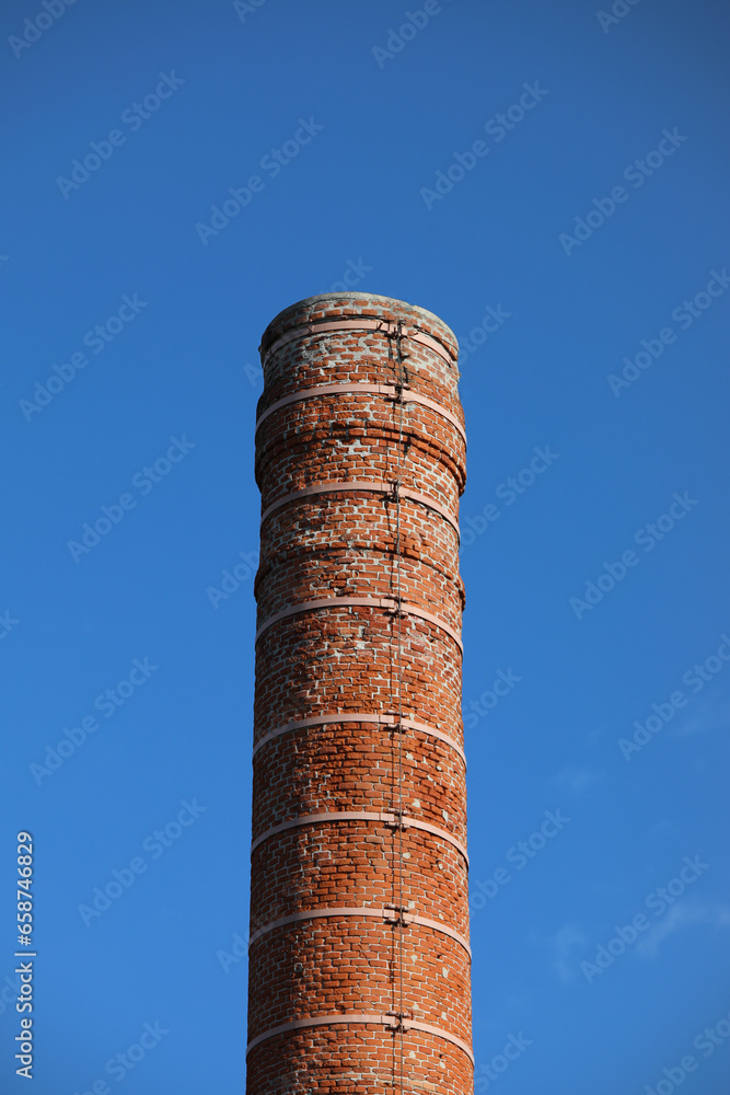 chimney made with exposed bricks of a buttock factory and the sky in the background