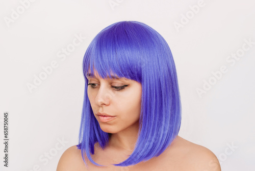 Young woman with dyed blue tinted hair isolated on white background. Result of coloring, tinting. Light delicate color. Beauty and fashion. Colored bright wig with square and bangs