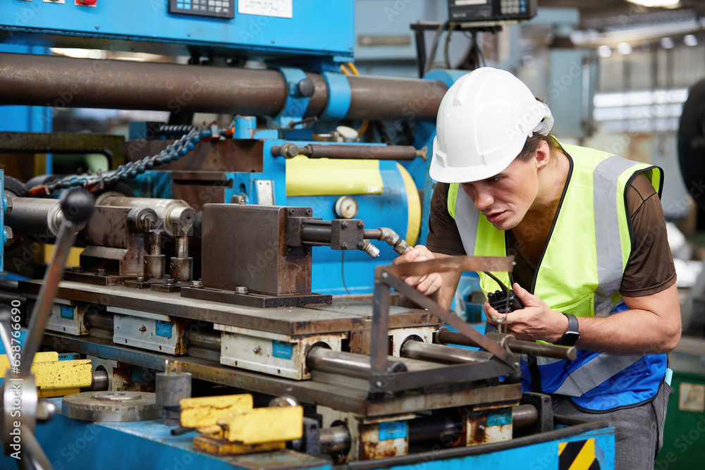 factory worker or technician checking and control lathe machine in factory