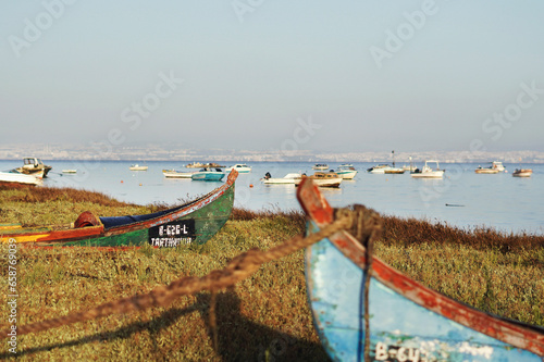 fishing boats on river shore