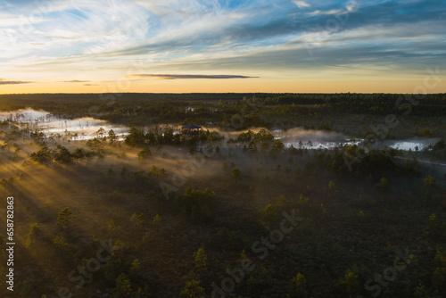 Nature of Estonia, sunrise on a swamp Viru in summer. Fog over the lakes. View from a drone.
