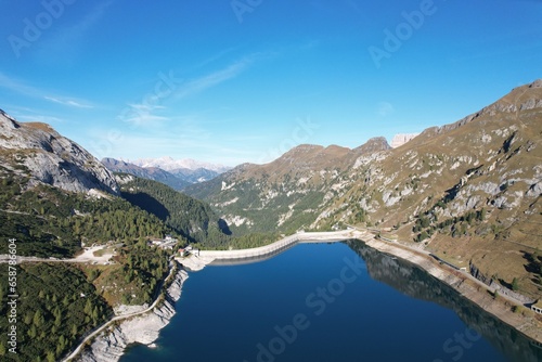 Fototapeta Naklejka Na Ścianę i Meble -  Fedaia Lake,Lago di Fedaia,Beautiful aerial landscape view of Italian Dolomites-with mountain meadows,lakes and rocky and sharp mountain tops,Dolomite Alps mountains, Canazei,Marmolada,Dolomites,Italy
