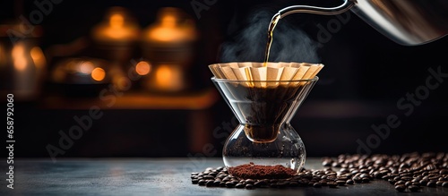 Alternative pouring method of water over filtered roasted and ground coffee beans for brewing drip filter coffee With copyspace for text photo