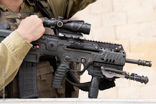Israeli assault rifle or machine gun in Israeli soldier's hands close up