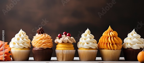 Autumn themed cupcakes with yellow and orange icing With copyspace for text photo