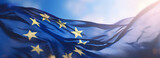 Flag of European Union waving in the breeze against a sunset sky. Banner with EU flag.