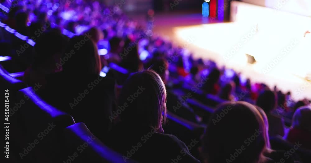 Audience at the modern conference hall listens to panel discussion ...