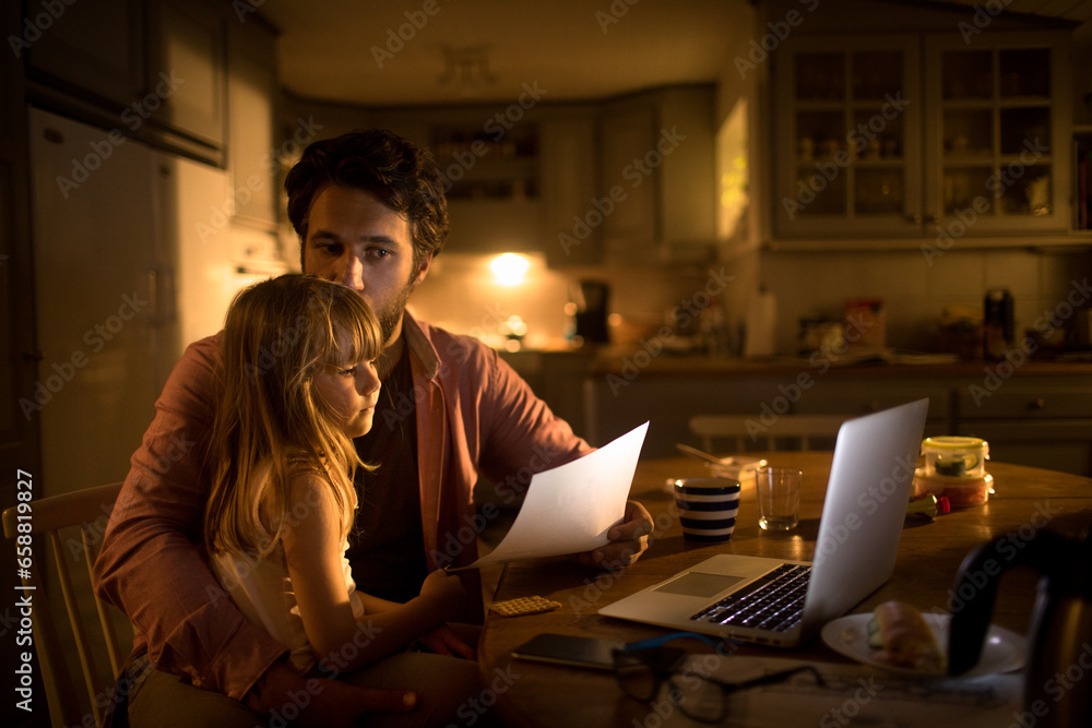 Young girl comforting his father during a financial crisis in the kitchen of their home - obrazy, fototapety, plakaty 