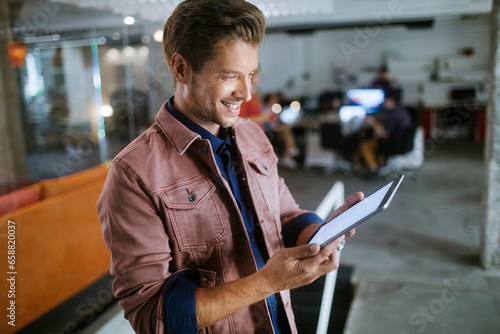 Young man using a tablet in the office of a startup company