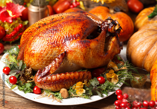 A golden roasted Christmas or thanksgiving turkey on a garnished plate