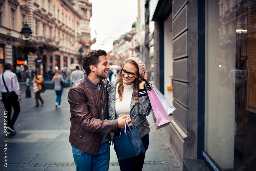 Attractive young couple walking and shopping in the city
