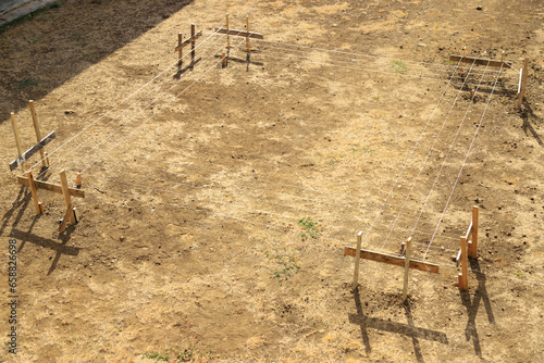 laying out the shape of a rectangular building on the ground with profile boards