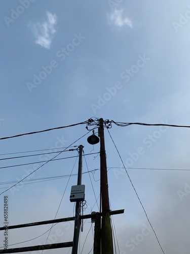 an electricity pole with a blue sky background