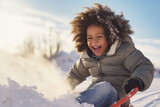 toddler child laughing and having fun on a snow sled
