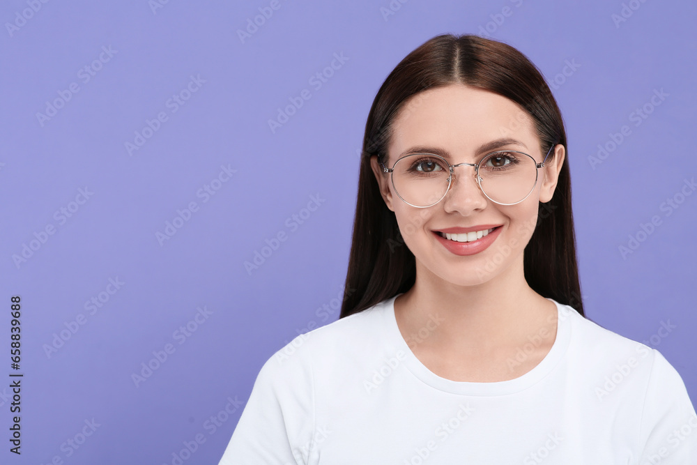Smiling woman in stylish eyeglasses on violet background. Space for text Smiling woman in stylish eyeglasses on violet background. Space for text