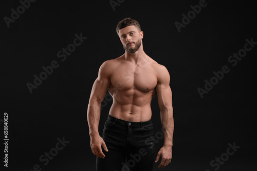 Handsome muscular man on black background. Sexy body