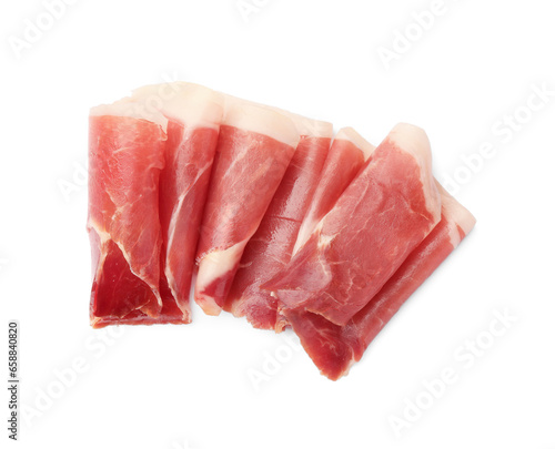 Slices of delicious jamon on white background, top view