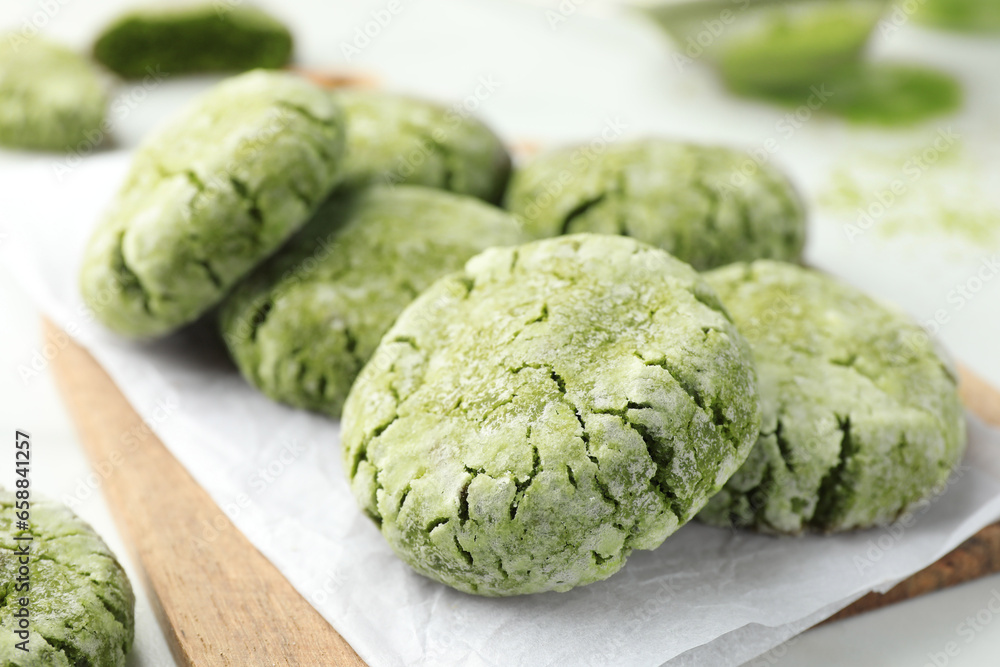 Board with tasty matcha cookies on white table, selective focus Board with tasty matcha cookies on white table, selective focus