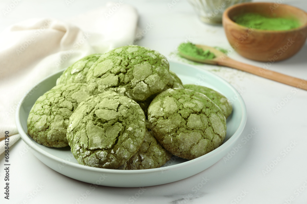 Plate with tasty matcha cookies on white table, closeup Plate with tasty matcha cookies on white table, closeup