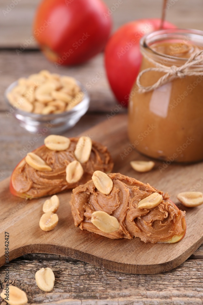 Fresh apples with peanut butter on wooden table Fresh apples with peanut butter on wooden table