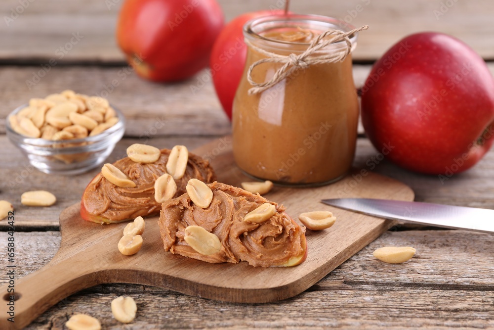 Fresh apples with peanut butter on wooden table Fresh apples with peanut butter on wooden table