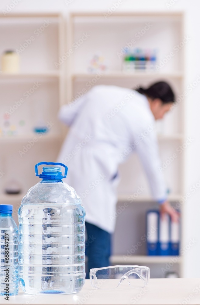 Young male chemist experimenting in lab Young male chemist experimenting in lab