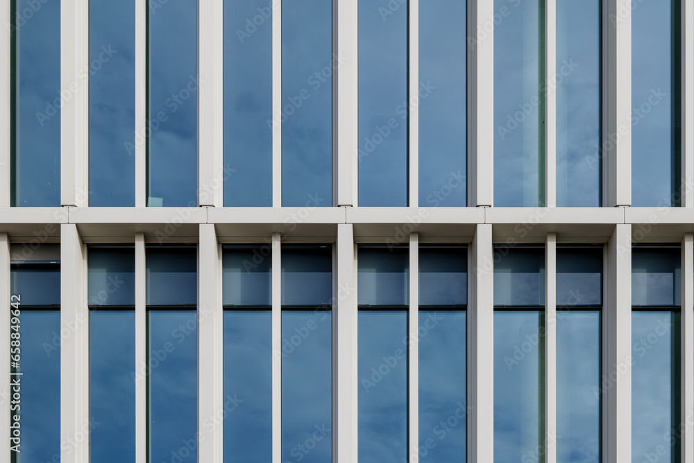 Outdoor exterior front view of modern facade with typical rectangular modern narrow vertical windows. Outdoor exterior front view of modern facade with typical rectangular modern narrow vertical windows.