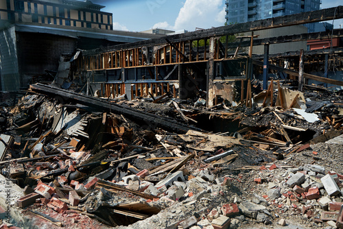 A burnt-out old wooden building after a fire. Charred beams after the destruction.