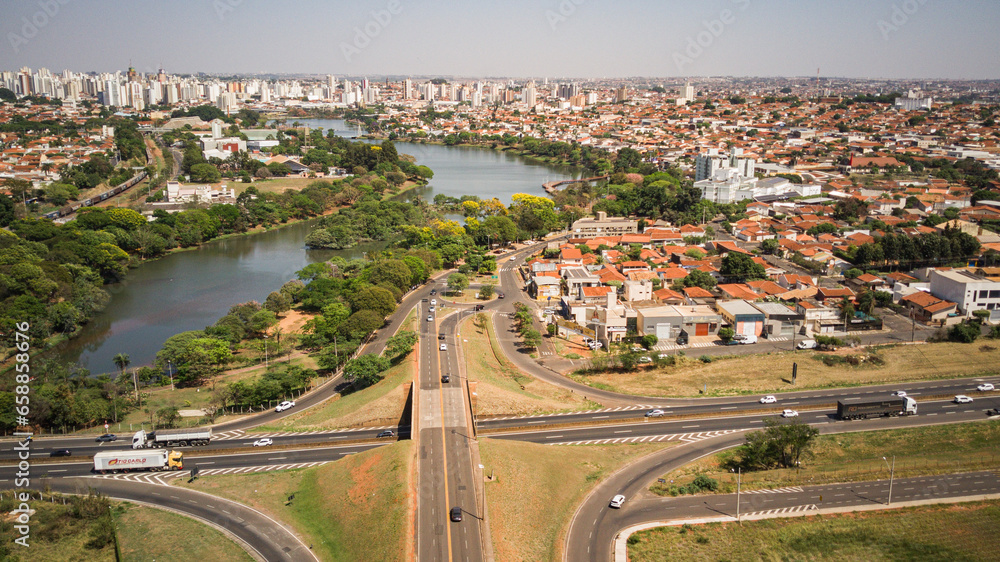 Fototapeta premium Aerial view of the Rio Preto municipal dam in drone panorama, aerial view on a sunny day with the avenues and highways and the park and the river in high resolution - Sao Jose do Rio Preto - Sao Paulo