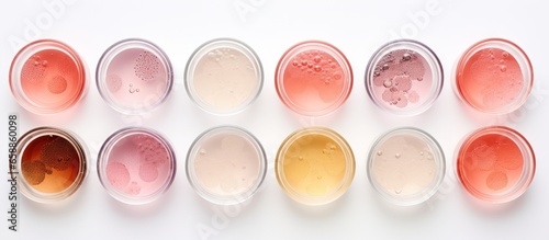 Top down view of Petri dishes containing cosmetics on a white background representing the concepts of skincare dermatology and natural organic cosmetic research