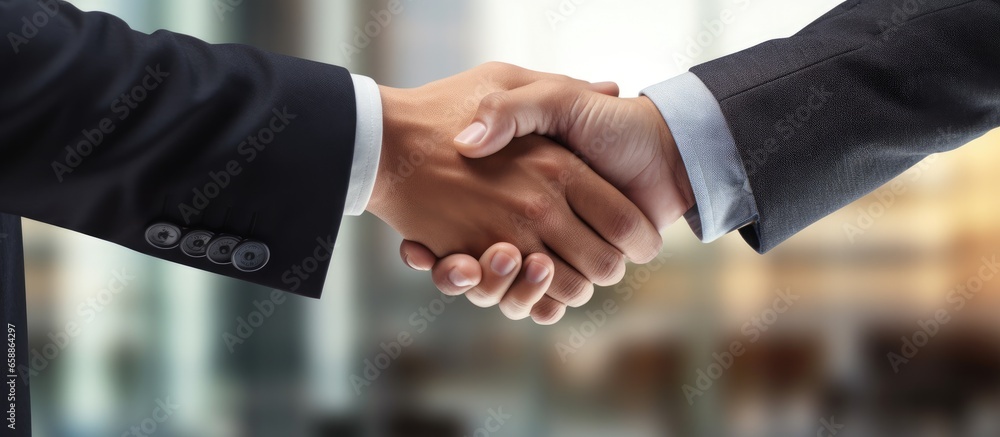 Colleagues shaking hands after meeting With copyspace for text