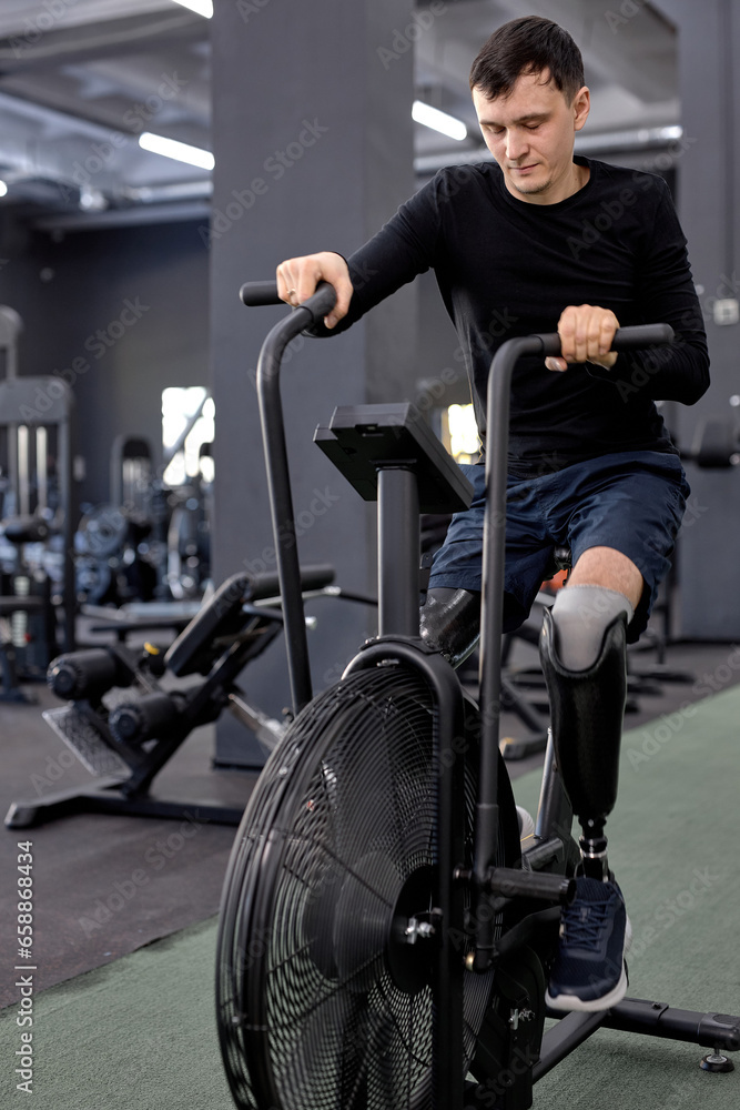 tired exhausted man with artificial legs working out on bike, tiredness, endurance tired exhausted man with artificial legs working out on bike, tiredness, endurance