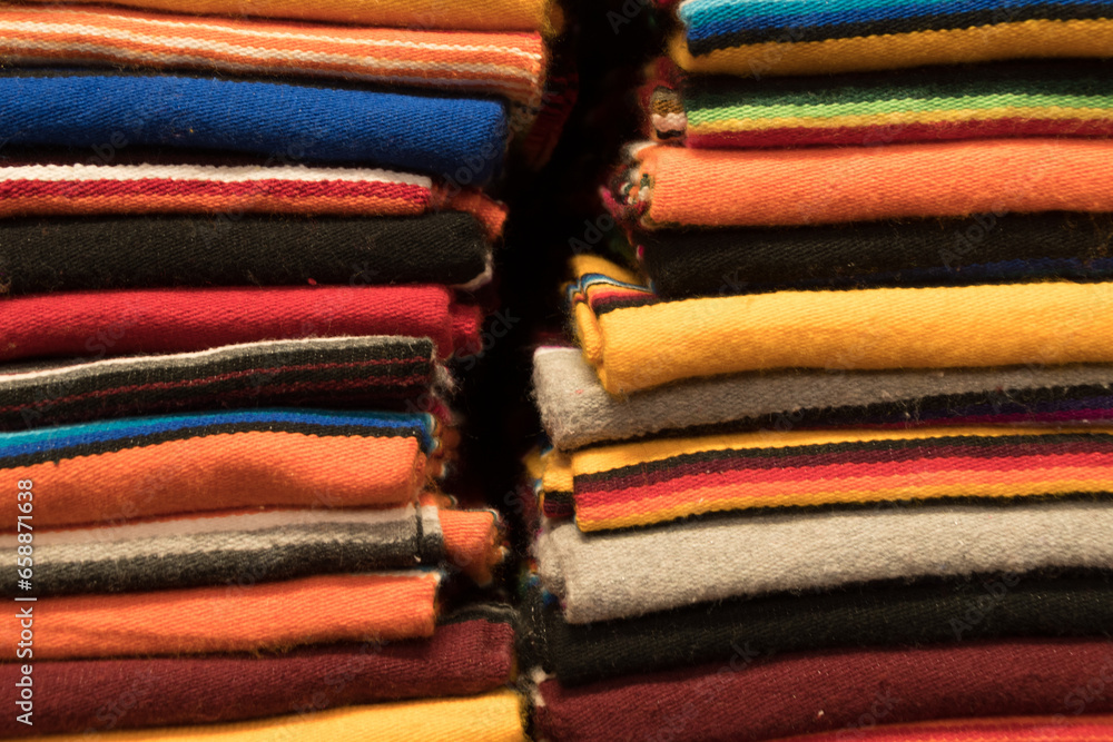 Pile of blankets in traditional indigenous style in market in Santa Fe -1 Pile of blankets in traditional indigenous style in market in Santa Fe -1